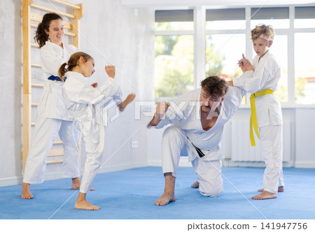 After training, parents and children have fun in gym 141947756
