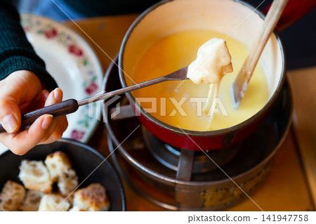 Fondue Savoyarde is a popular dish of the Savoy region Fondue Savoyarde is a popular dish of the Savoy region 141947758