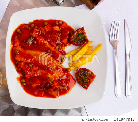 Tilapia fillet with vegetables, french fries and sun-dried tomatoes Tilapia fillet with vegetables, french fries and sun-dried tomatoes 141947812