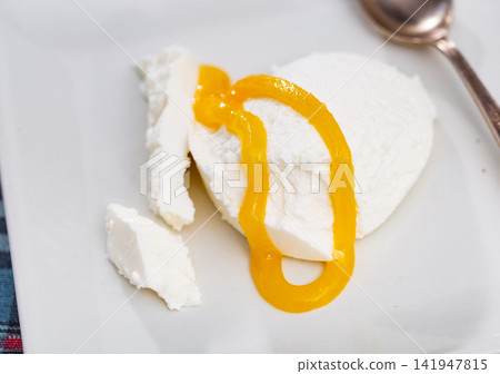 Mato con miel, soft cheese from sheep milk served with honey 141947815