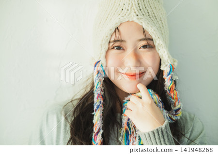 Portrait of a woman wearing a knitted hat Portrait of a woman wearing a knitted hat 141948268