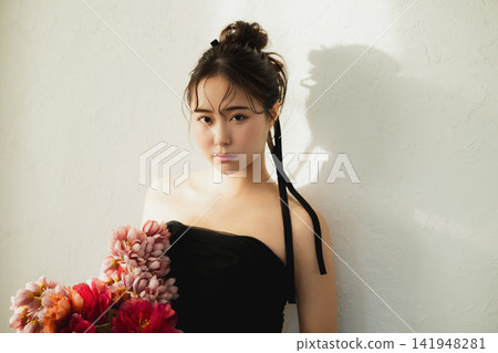 A woman in a black dress A woman in a black dress 141948281