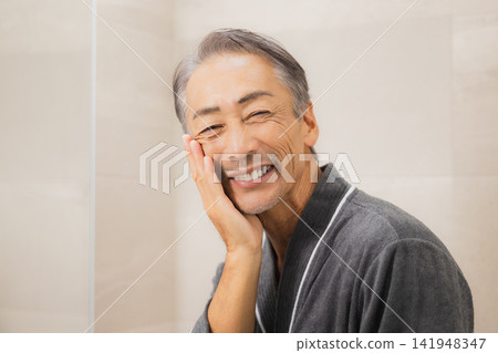 Senior men laughing at the mirror Senior men laughing at the mirror 141948347