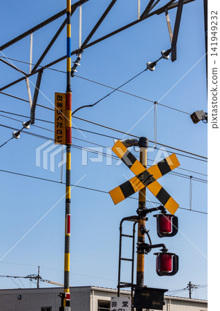 Blue sky and railway crossing warning lights/barriers (vertical composition, looking up angle) Blue sky and railway crossing warning lights/barriers (vertical composition, looking up angle) 141949232