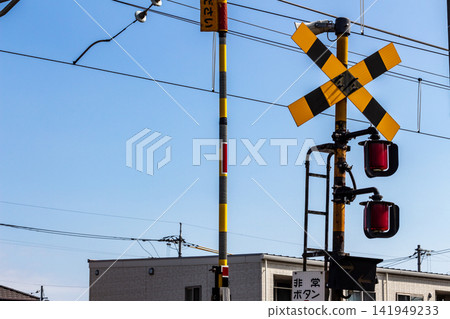 Blue sky and railway crossing warning signals and barriers Blue sky and railway crossing warning signals and barriers 141949233