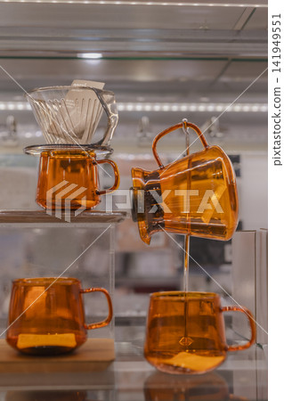 Glass coffee drippers and servers lined up in a general store. Glass coffee drippers and servers lined up in a general store. 141949551