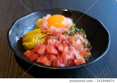 A luxurious seafood bowl with tuna, minced tuna, and avocado. 141949674