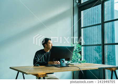 A man working on a computer A man working on a computer 141949705