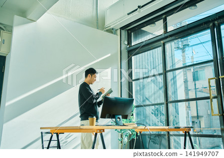 A man working on a computer A man working on a computer 141949707