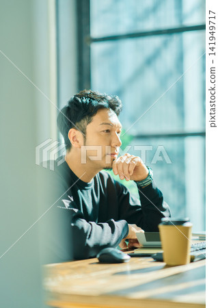 A man working on a computer A man working on a computer 141949717