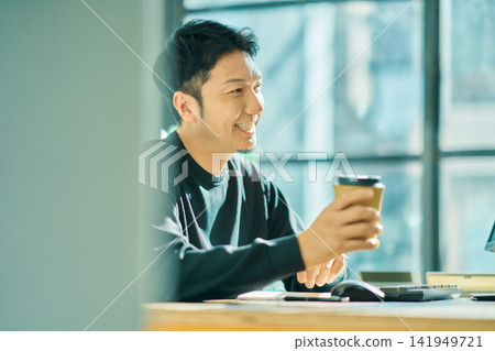 A man working on a computer A man working on a computer 141949721