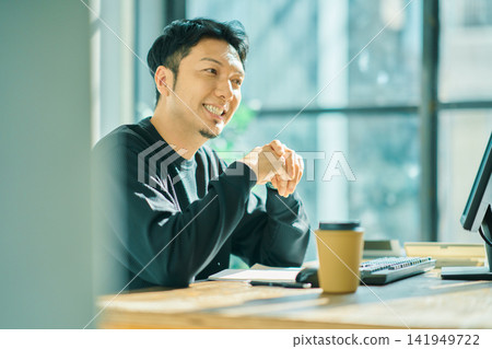 A man working on a computer A man working on a computer 141949722