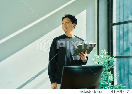 A man working on a computer A man working on a computer 141949727