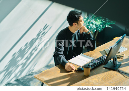 A man working on a computer A man working on a computer 141949734