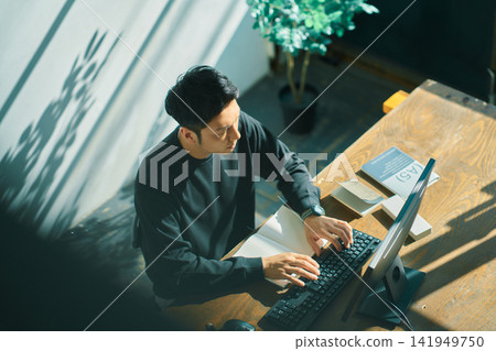 A man working on a computer A man working on a computer 141949750
