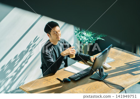 A man working on a computer A man working on a computer 141949751