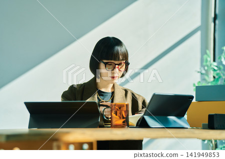 Young woman working in the office Young woman working in the office 141949853
