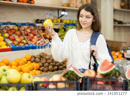 Young woman choosing apples at vegetable market Young woman choosing apples at vegetable market 141951277