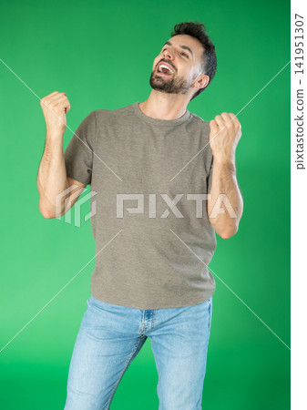 Portrait of successful, happy man against green background. Expression of emotion after successful outcome. Chroma key compositing Portrait of successful, happy man against green background. Expression of emotion after successful outcome. Chroma key compositing 141951307