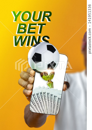 Winning sports bet on a mobile device with soccer ball and cash displayed Winning sports bet on a mobile device with soccer ball and cash displayed 141951336