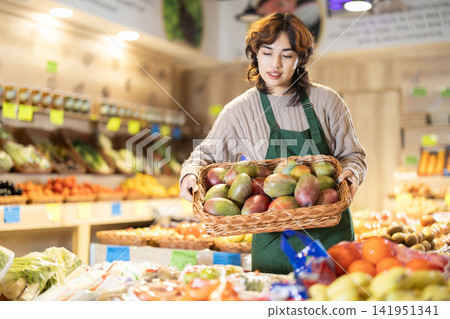 Eco food vegetable market, girl worker and mango. Eco food vegetable market, girl worker and mango. 141951341