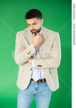 Adult man sad and upset in front of green screen Adult man sad and upset in front of green screen 141951382