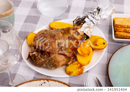 Baked leg of lamb with eggplant and potatoes on plate Baked leg of lamb with eggplant and potatoes on plate 141951404