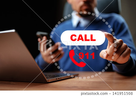 Emergency call to 911 from a person using a phone and laptop in an indoor setting Emergency call to 911 from a person using a phone and laptop in an indoor setting 141951508