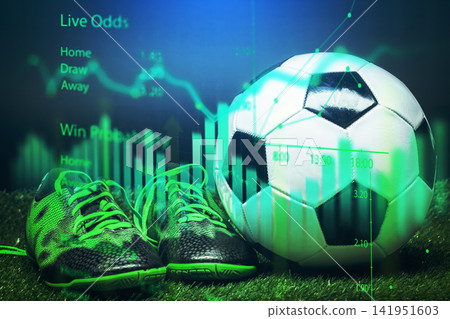Live odds for sports betting displayed with a soccer ball and shoes on green grass Live odds for sports betting displayed with a soccer ball and shoes on green grass 141951603
