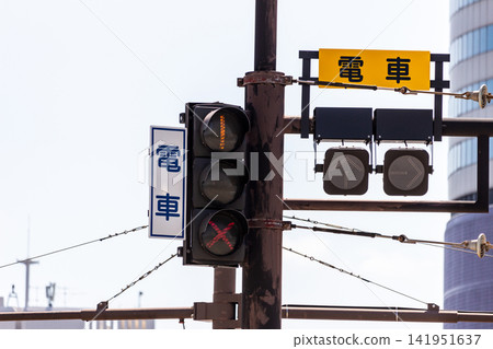 Traffic signals and signs for trams (looking up, against a blue sky background) Traffic signals and signs for trams (looking up, against a blue sky background) 141951637
