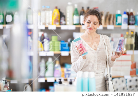 Young woman choosing razor in retail store Young woman choosing razor in retail store 141951657