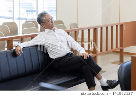 A senior man with a bad attitude awaits trial in court. A senior man with a bad attitude awaits trial in court. 141952127