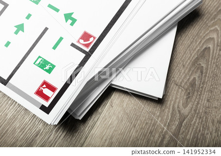 Emergency 911 plan with clear signs for exits and safety equipment on a wooden floor 141952334