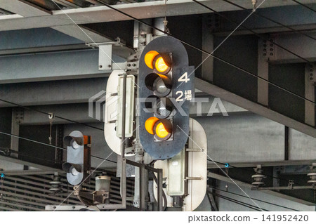Illuminated railway station signals and station equipment (low-angle close-up) Illuminated railway station signals and station equipment (low-angle close-up) 141952420