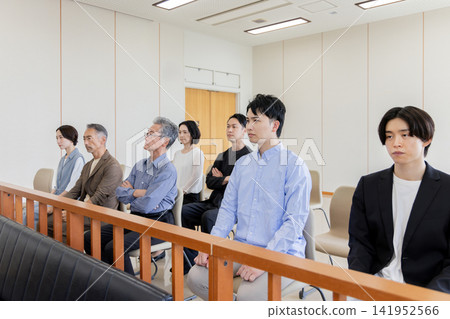 People of various generations watching the trial from the courtroom gallery. People of various generations watching the trial from the courtroom gallery. 141952566