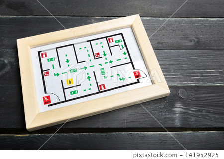 Evacuation plan showing escape routes and emergency exits for a building Evacuation plan showing escape routes and emergency exits for a building 141952925
