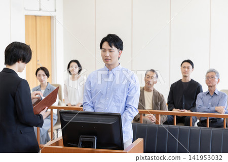 A young man testifying in court and spectators watching the trial. A young man testifying in court and spectators watching the trial. 141953032
