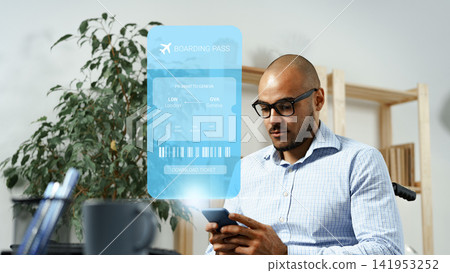 Travel planning process with boarding pass displayed on a device while a man looks at his phone Travel planning process with boarding pass displayed on a device while a man looks at his phone 141953252
