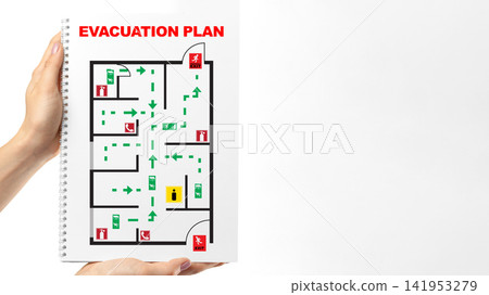Emergency evacuation plan displayed in a guidebook showing exit routes and safety instructions clearly marked Emergency evacuation plan displayed in a guidebook showing exit routes and safety instructions clearly marked 141953279