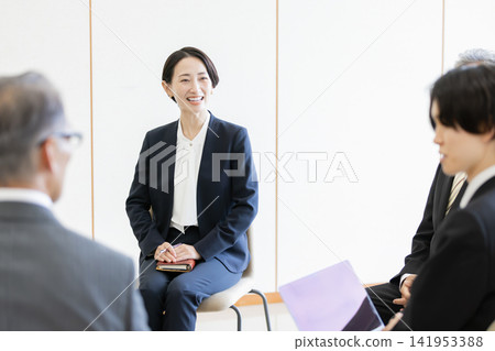 Multigenerational business teams exchanging ideas in a business meeting. Multigenerational business teams exchanging ideas in a business meeting. 141953388