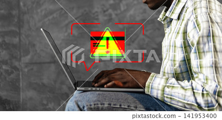 Fake payment warning on laptop screen in an office setting with a person focused on their task Fake payment warning on laptop screen in an office setting with a person focused on their task 141953400