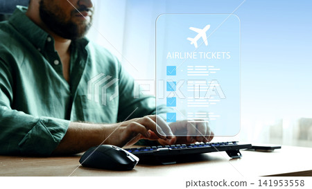 Travel booking for airline tickets using a computer at a desk during the day 141953558