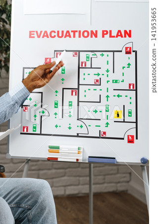 Emergency evacuation plan presentation in office setting with clear escape routes marked Emergency evacuation plan presentation in office setting with clear escape routes marked 141953665