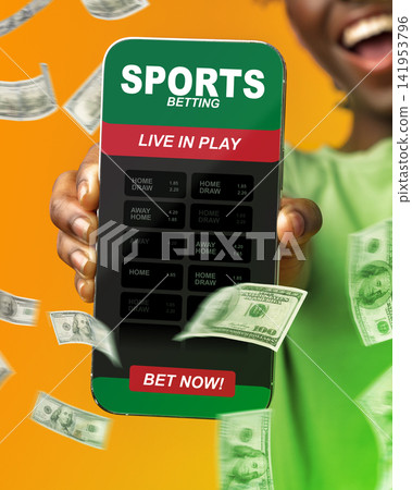 Person places bets on a mobile app for sports betting with money flying around in the background Person places bets on a mobile app for sports betting with money flying around in the background 141953796