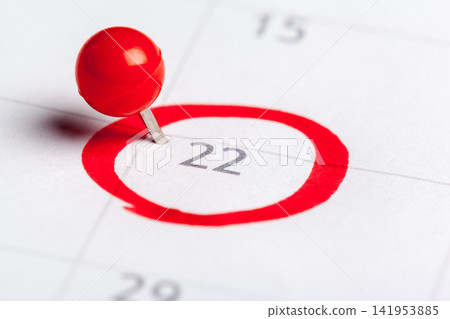Important date marked with a pin on a calendar for the 22nd day of the month Important date marked with a pin on a calendar for the 22nd day of the month 141953885