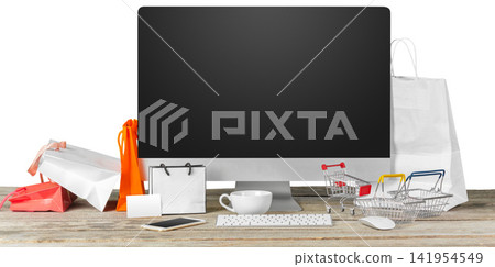 Computer screen surrounded by shopping bags and mini carts Computer screen surrounded by shopping bags and mini carts 141954549