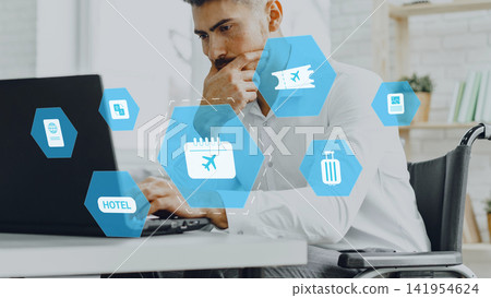 Man booking travel online while using laptop in a modern office space with travel icons displayed on screen Man booking travel online while using laptop in a modern office space with travel icons displayed on screen 141954624