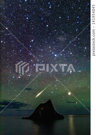 A brilliant fireball streaks across the sky above countless stars and Window Rock. A brilliant fireball streaks across the sky above countless stars and Window Rock. 141954845