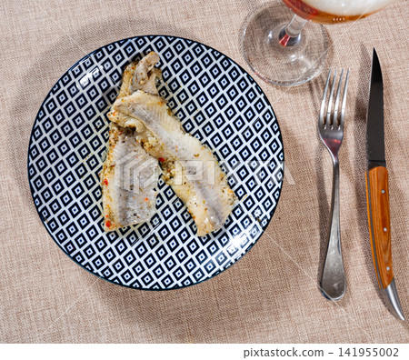 Pieces of pickled herring served on platter Pieces of pickled herring served on platter 141955002