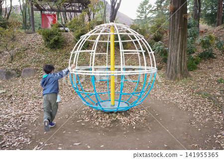 Children playing energetically in the park and the Earth Gym Children playing energetically in the park and the Earth Gym 141955365